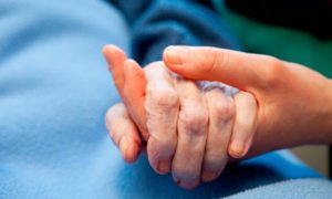 Patient holding hands